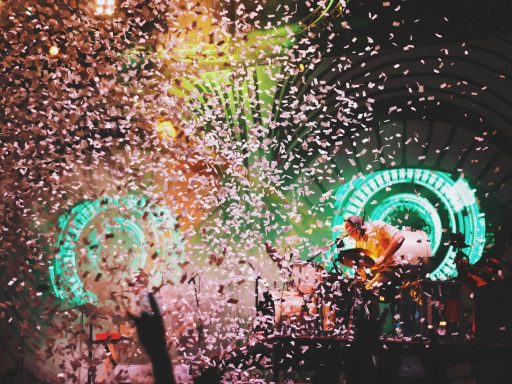 pink confetti dropping on lighted stage