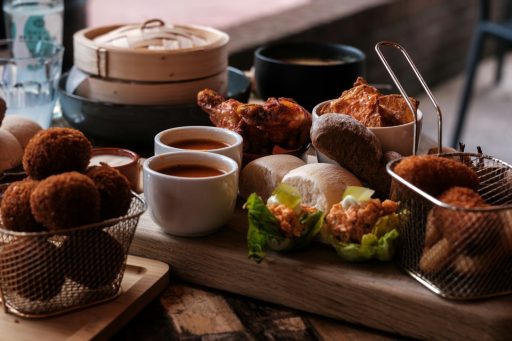 a wooden table topped with baskets filled with food