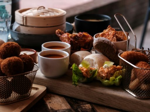 a wooden table topped with baskets filled with food