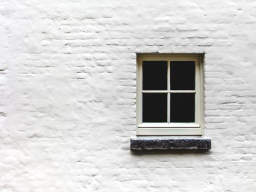 white wall with window close-up photography