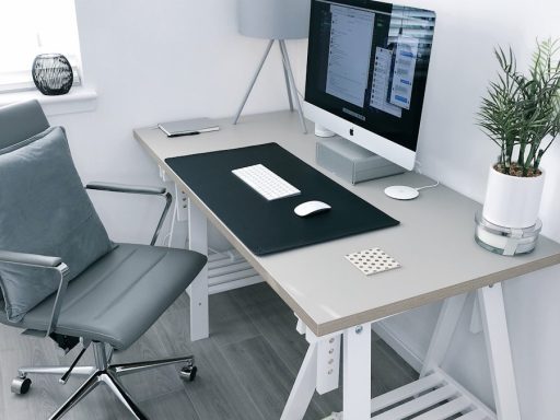 gray leather office rolling armchair beside white wooden computer desk