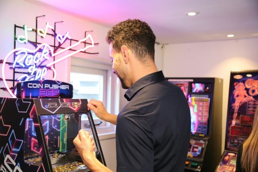 A man is playing a video game in a room