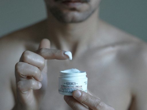 a man holding a jar of cream in his hand