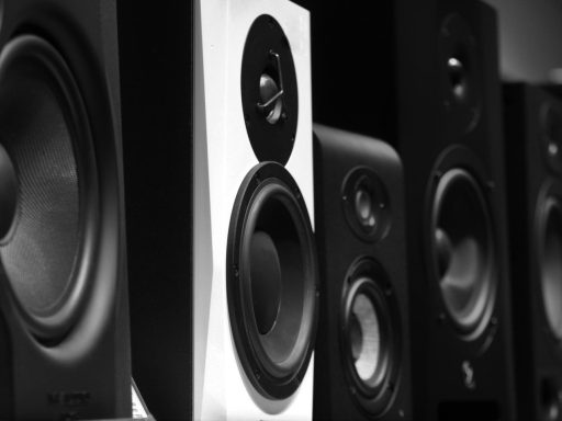 black and gray speakers on brown wooden table